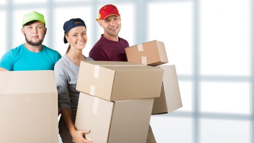 Professional movers loading furniture for a local relocation